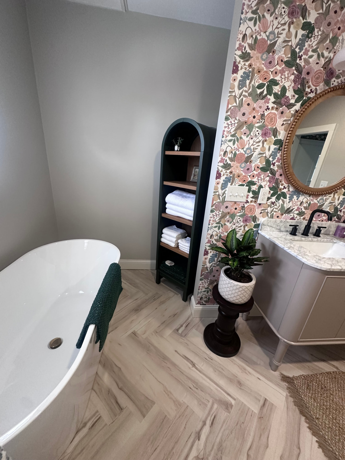Bathroom with freestanding soaking tub and floral wallpaper